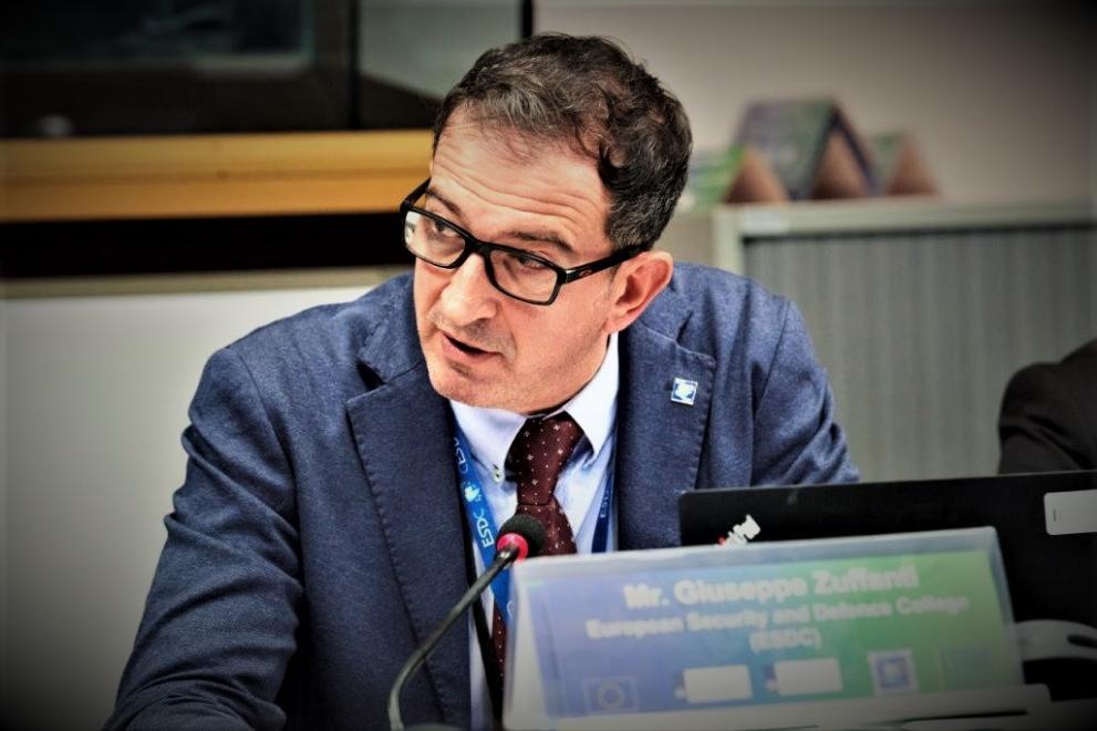 Picture of Giuseppe Zuffanti giving a speech, sitting down, suit and tie