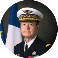 Brigadier General Didier Oustric in the Uniform of the French Airforce. In front of the French and EU flag.