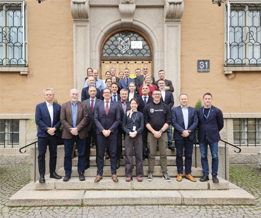 Group of participants wearing mostly formal wear in front of the Swedish Defence University