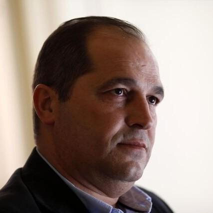 Fernando Angelo, neutral look on his face. 