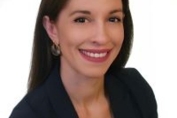Dr. Eleni KAPSOKOLI in a dark blaizer and white top