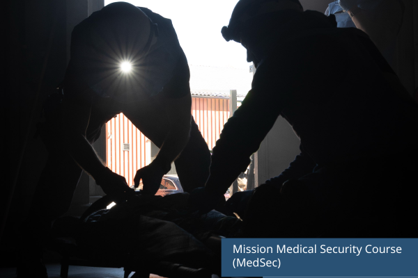Multiple people in the dark with flash lights on their helmet helping an injured person laying down. The text on the picture reads: Mission Medical Security Course (MedSec) organised by the Swedish Civil Defence and Resilience Agency